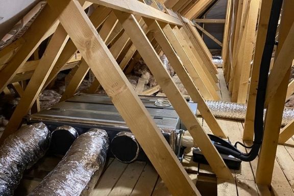 Air conditioning unit in loft rafters in barn conversion project